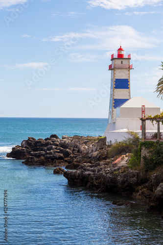 lighthouse on ocean coast in bay cascais