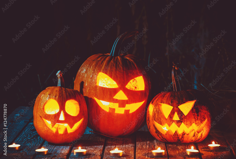 Halloween Pumpkins head jack lantern on the old boards in a spooky night landscape. Soft focus. shallow DOF Halloween Pumpkins head jack lantern on the old boards in a spooky night landscape. Soft focus. shallow DOF