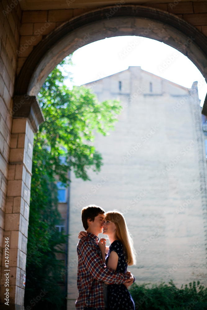 young couple on background of architecture arch