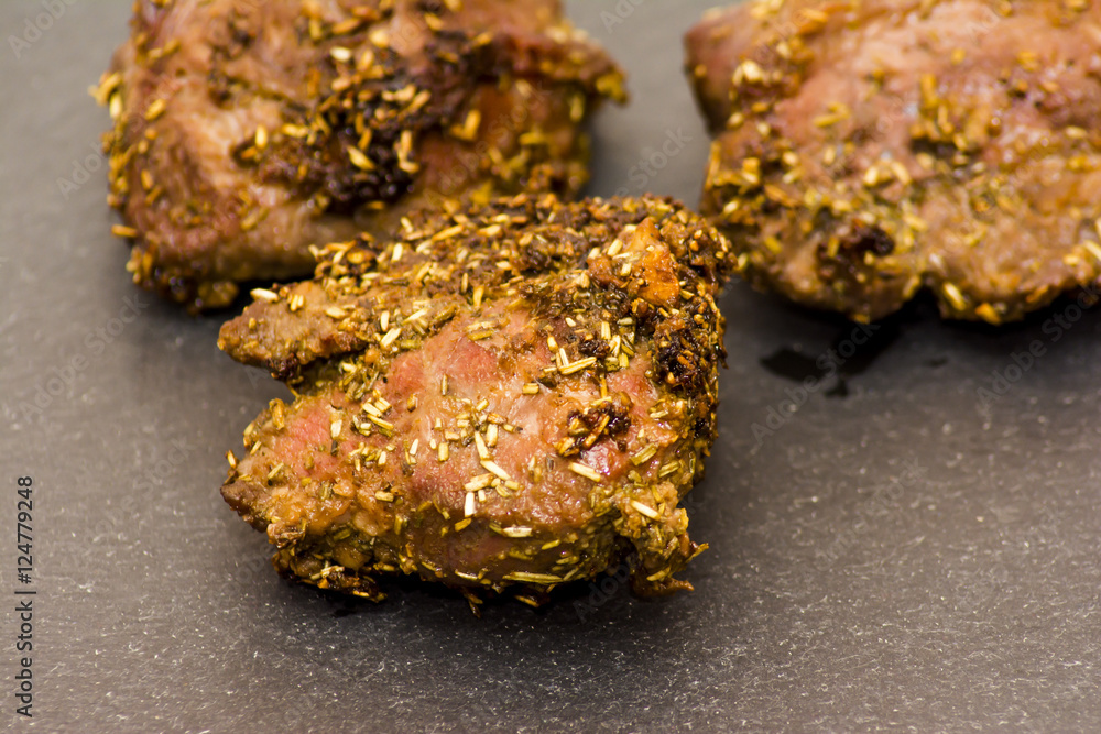Pork cheeks with species on a stone slate Pork cheeks with species on a stone slate
