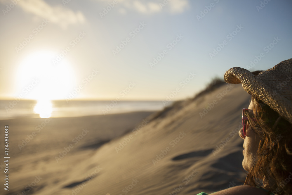 Profile of an adult woman watching the sunset on a beach at Conejo. Baja California, Mexico. Profile of an adult woman watching the sunset on a beach at Conejo. Baja California, Mexico.