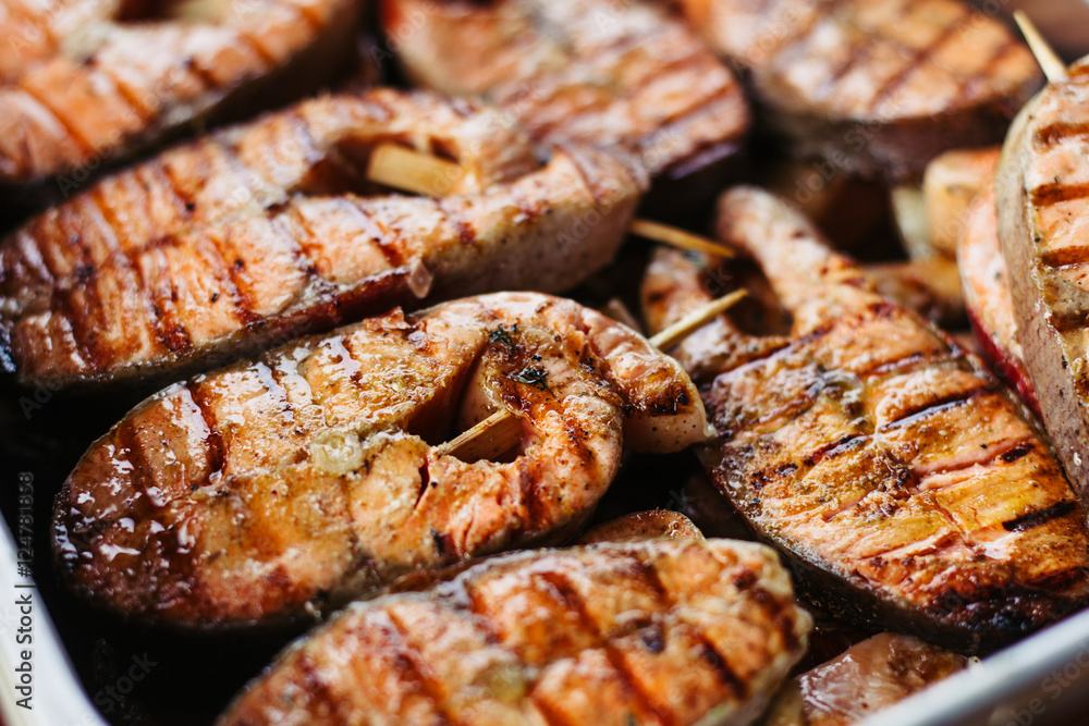Grilled salmon steak on the flaming. Side view. Close-up. Grilled salmon steak on the flaming. Side view. Close-up.