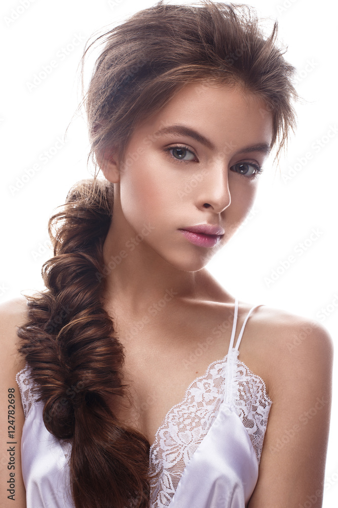 Beautiful girl in image of bride with plait. Model with nude makeup and silk underwear. Beauty face. Photo was taken in a studio. Beautiful girl in image of bride with plait. Model with nude makeup and silk underwear. Beauty face. Photo was taken in a studio.