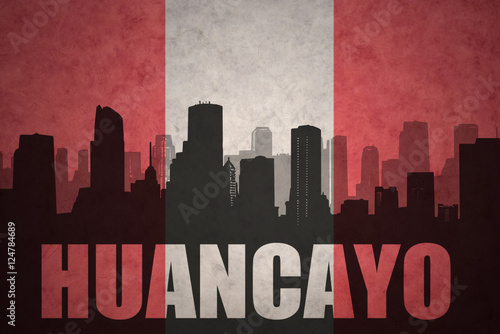 abstract silhouette of the city with text Huancayo at the vintage peruvian flag
