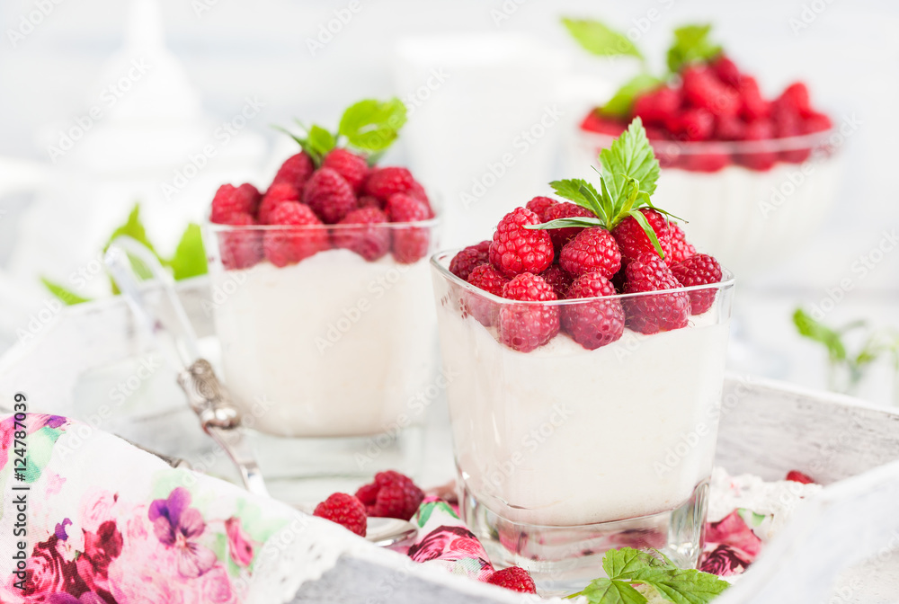 Delicious sweet mousse decorated with fresh raspberries Delicious sweet mousse decorated with fresh raspberries
