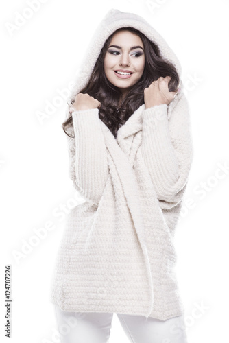 Beautiful young woman in warm sweater with a hood