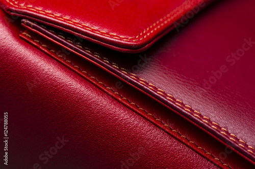 Red leather bag with pocket and stitches, woman's accessories, fashion industry, macro shot, selective focus, abstraction 
