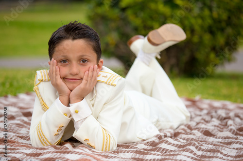 Wallpaper Mural Young First Communion boy lying on a blanket over the grass Torontodigital.ca