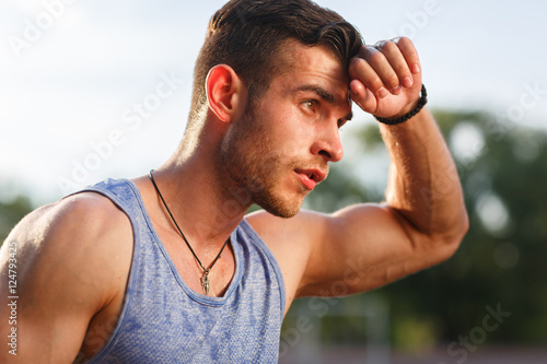 Photography Young muscular sweaty man after workout outside on sunny day