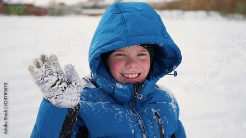 child standing and sweet smiling in winter time.