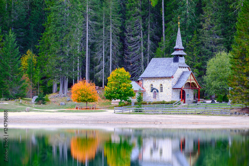 Little chapel at the Braies Lake in Dolomites mountains