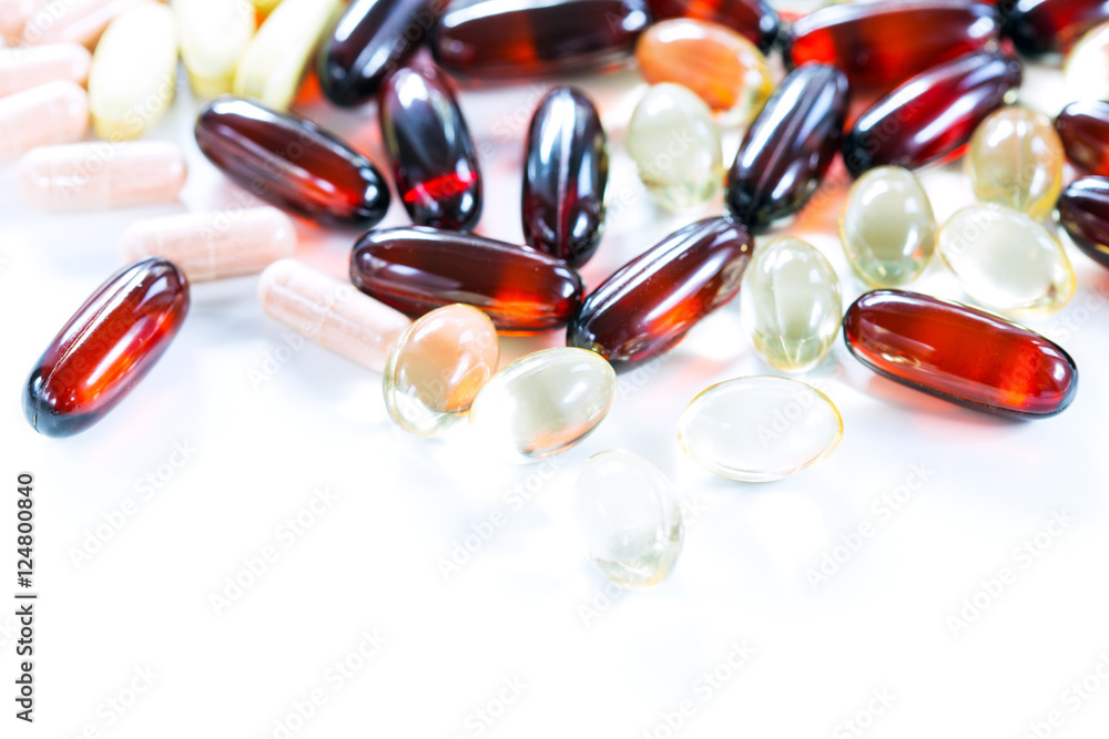 Vitamins, omega 3, cod-liver oil, dietary supplement and tablets an embankment on a light background close up, the top view Vitamins, omega 3, cod-liver oil, dietary supplement and tablets an embankment on a light background close up, the top view