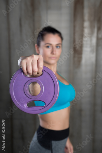Sporty athletic woman ready for hard training with weights. Cros