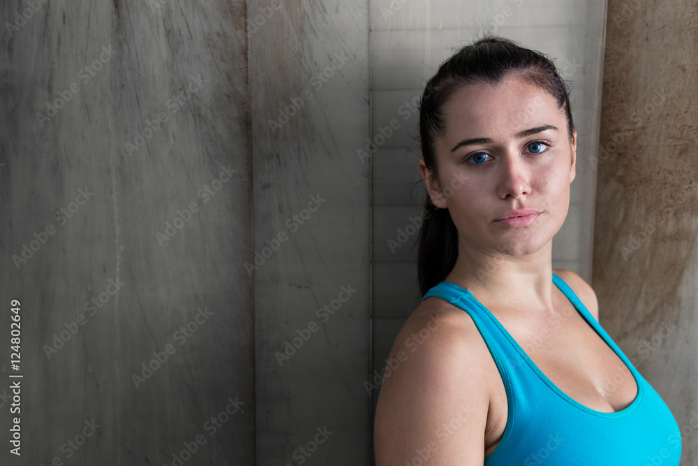 Image of muscular young woman posing in sportswear against rusti Image of muscular young woman posing in sportswear against rusti