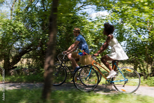 Young multiethnic couple having a bike ride in nature © .shock