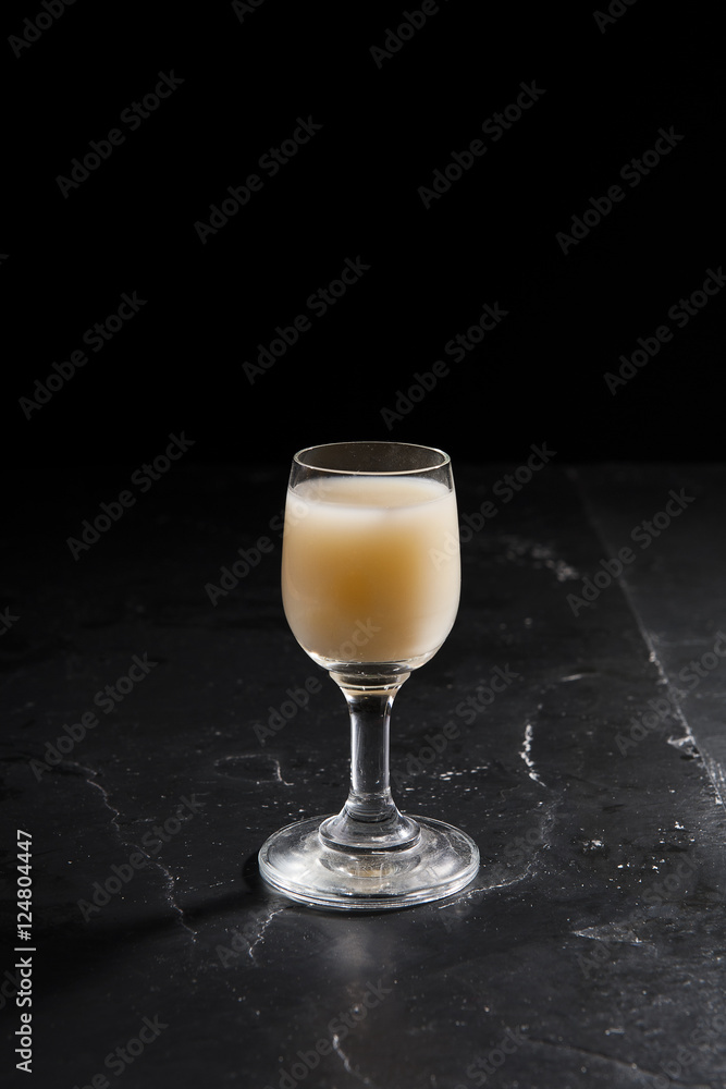 eggnog in liqueur glasses on a dark background eggnog in liqueur glasses on a dark background