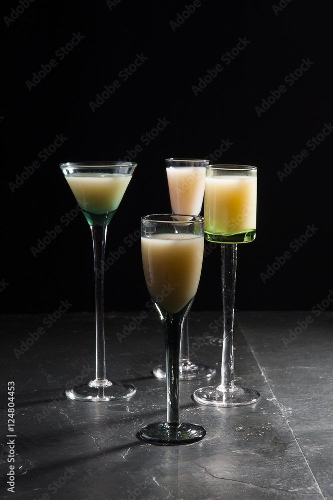 eggnog in liqueur glasses on a dark background 