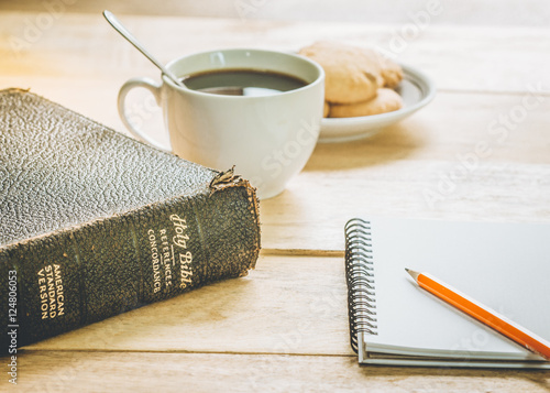 Tablou pe pânză image of the old book with small note book, pencil and a cup of coffee on wooden