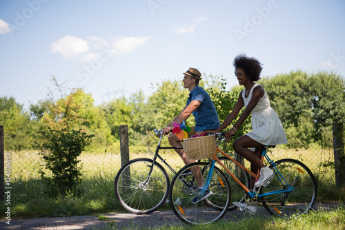Young multiethnic couple having a bike ride in nature