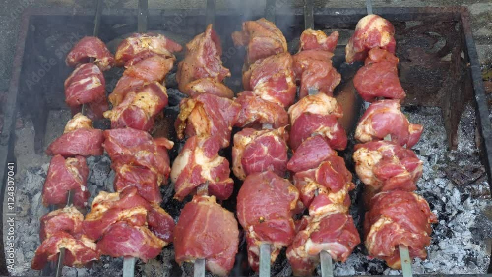 Raw meat on the skewers on the grill. Raw meat on the skewers on the grill.