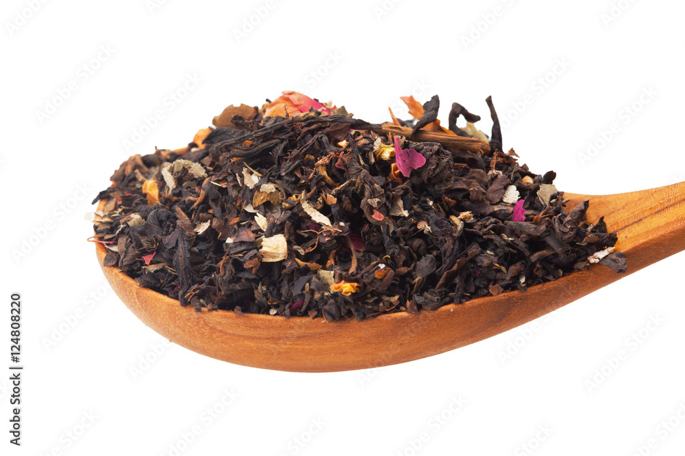 Fototapeta premium Close up of dry tea in wooden spoons.Selective focus on isolated background with clipping path