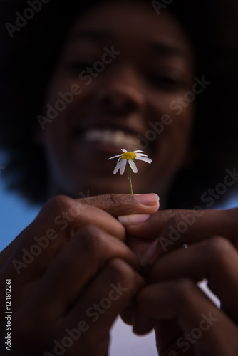 portrait of African American girl with a flower in her hand