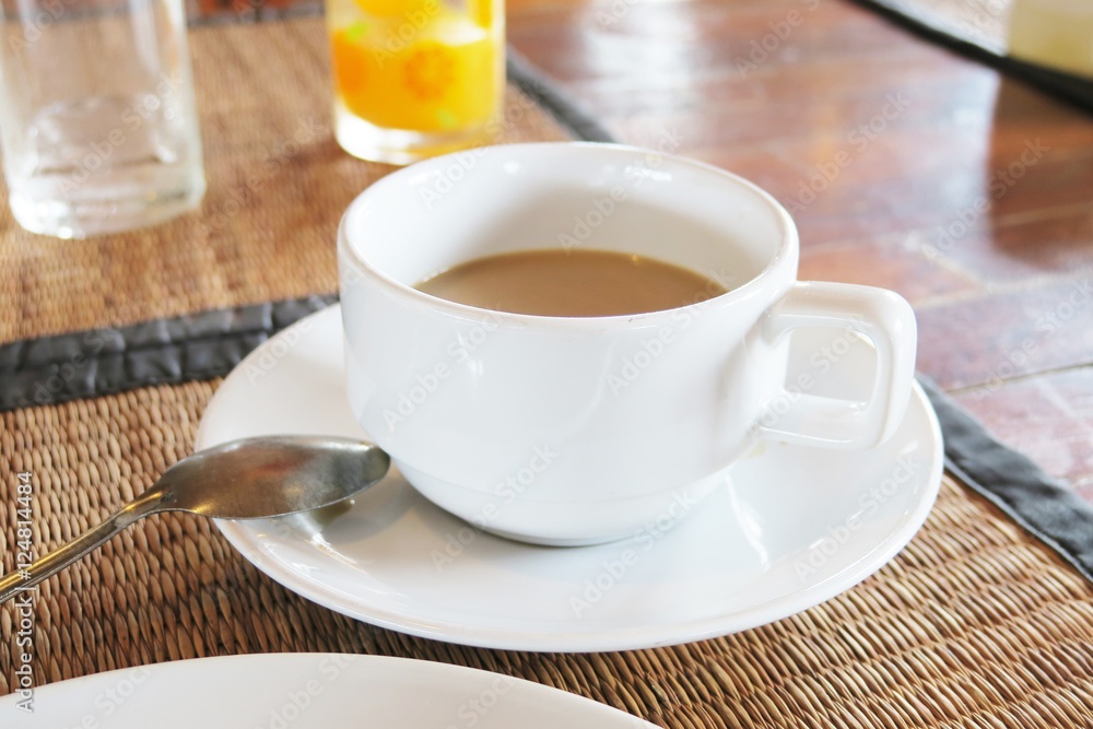 Cup of coffee on table. Breakfast and hot coffee background Cup of coffee on table. Breakfast and hot coffee background