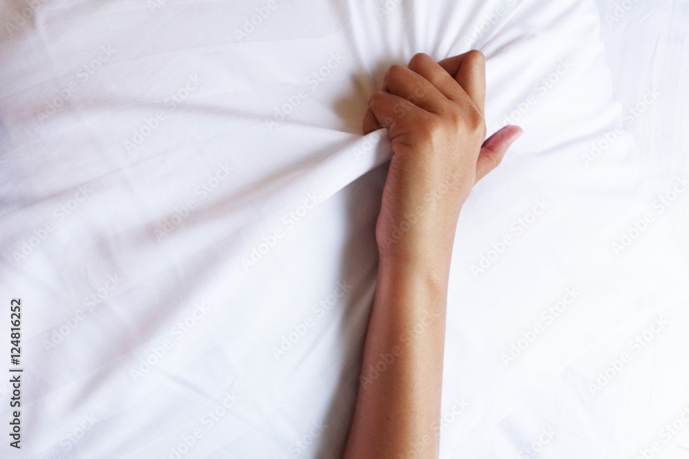 hand of women pulling white sheets in ecstasy, orgasm. hand of women pulling white sheets in ecstasy, orgasm.