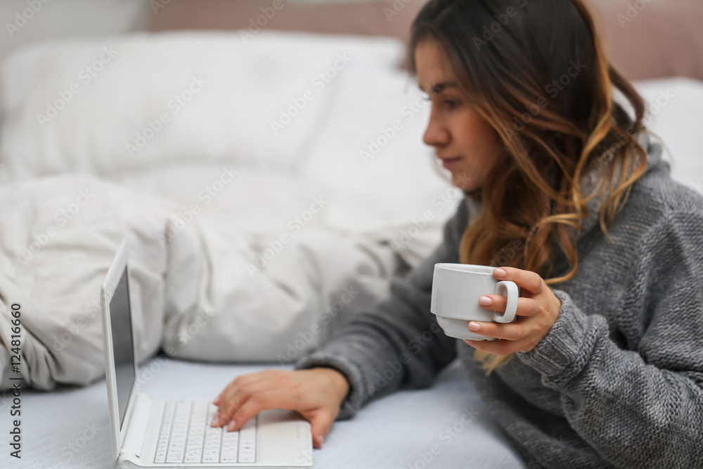 Girl in bed with a Cup and computer Girl in bed with a Cup and computer