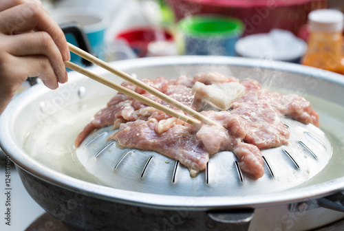  Grilling sliced pork and meat with ingredients on hot pan asian