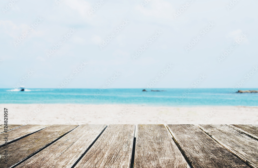 Fototapeta premium The Beach in Summer, wooden terrace with defocused tropical beach