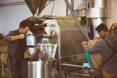 Obraz na plátně Two men working at coffee roasting factory
