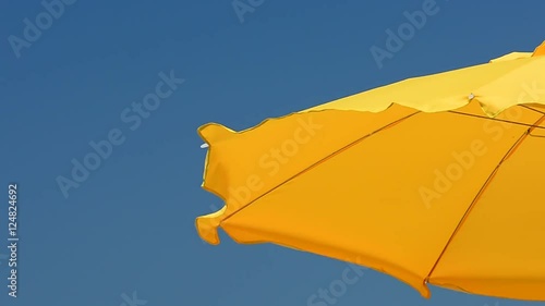 The umbrella on the beach and the wind