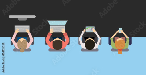 Team work at the table. Concept of brainstorming, making project , discussions. People with laptops, smartphone and tablet. Seen from above.