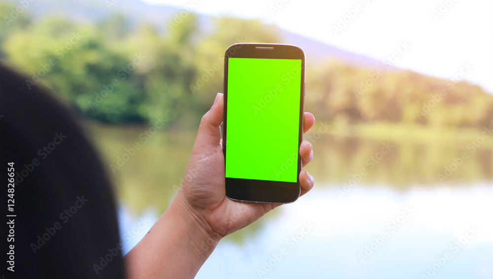 woman hands touching smartphone.green screen display