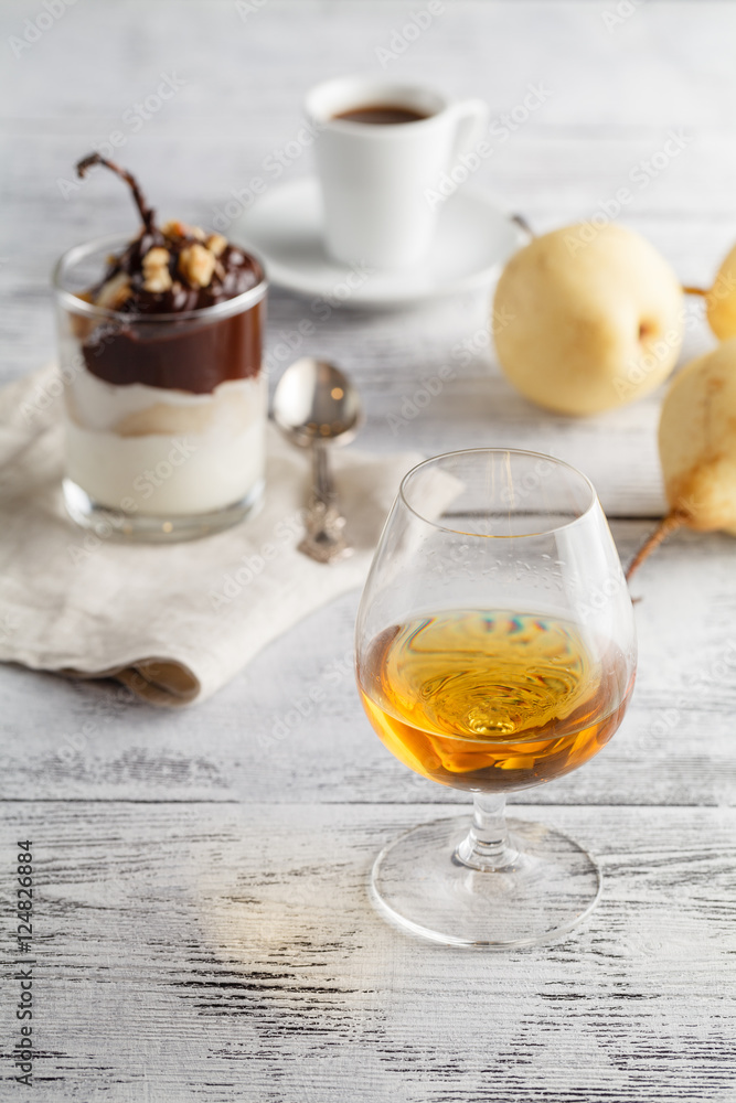 Cup of coffee, cognac glass and coffee beans on a wooden table Cup of coffee, cognac glass and coffee beans on a wooden table