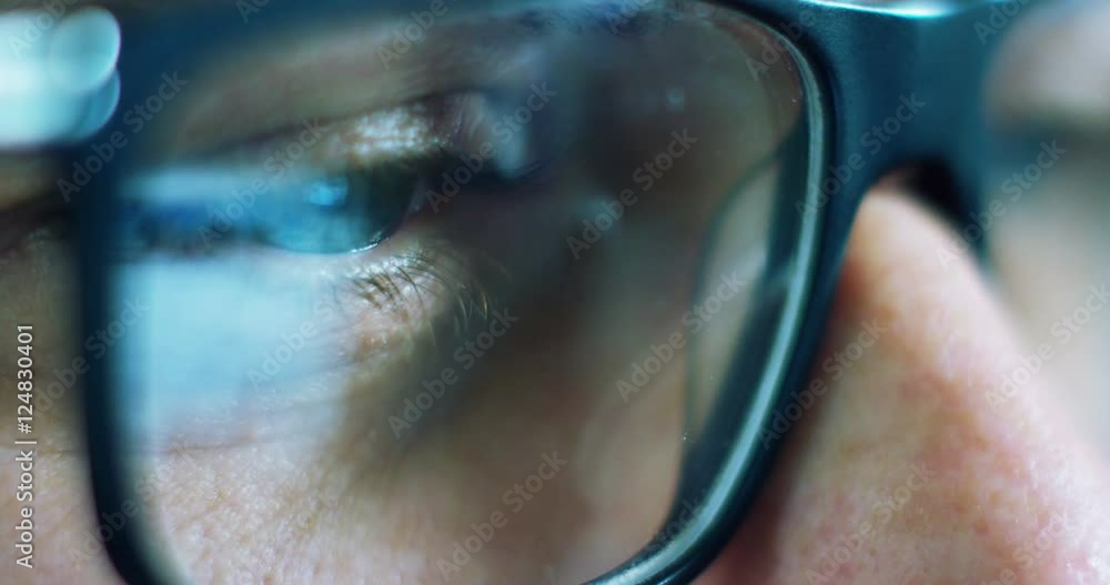 Close up of young businessman with blue eyes wearing the glasses looking on the waveform lines expressed concept of stock market, growth stock market, economic profits, stock exchange Close up of young businessman with blue eyes wearing the glasses looking on the waveform lines expressed concept of stock market, growth stock market, economic profits, stock exchange
