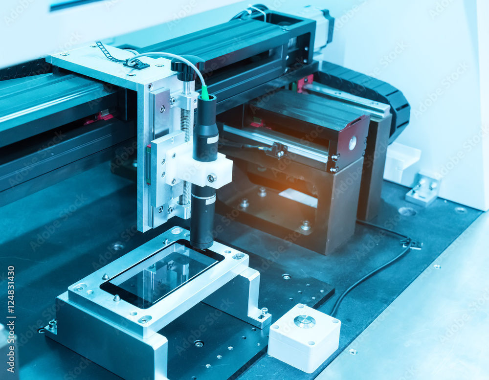 Industrial robot working in phone factory Industrial robot working in phone factory