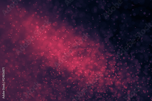 Dark pink abstract background with bokeh.