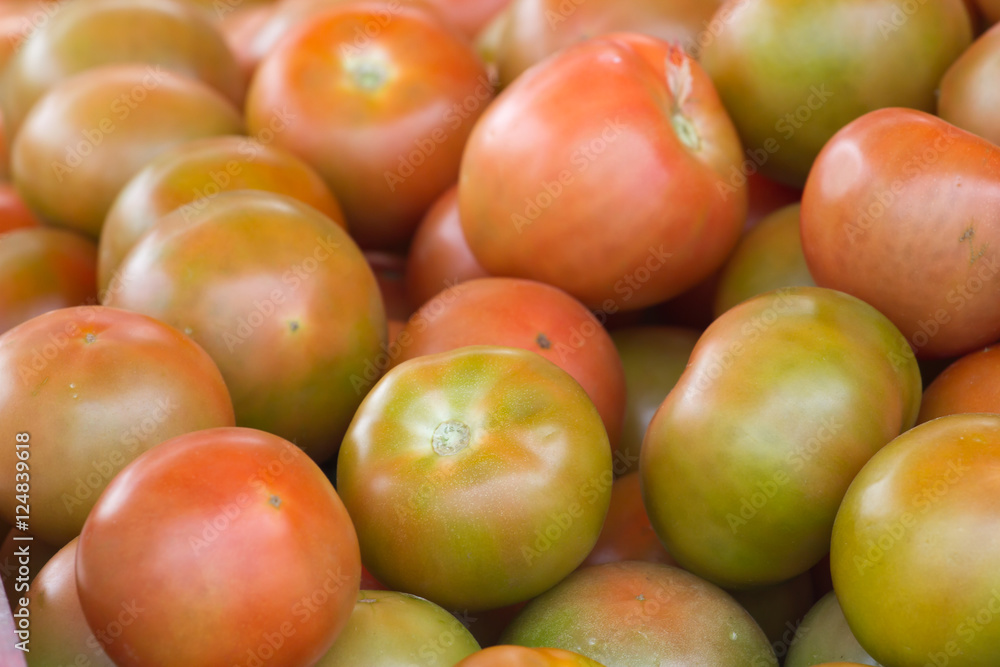 Group of tomatoes in market place. Red round ripe background. Ketchup production Group of tomatoes in market place. Red round ripe background. Ketchup production