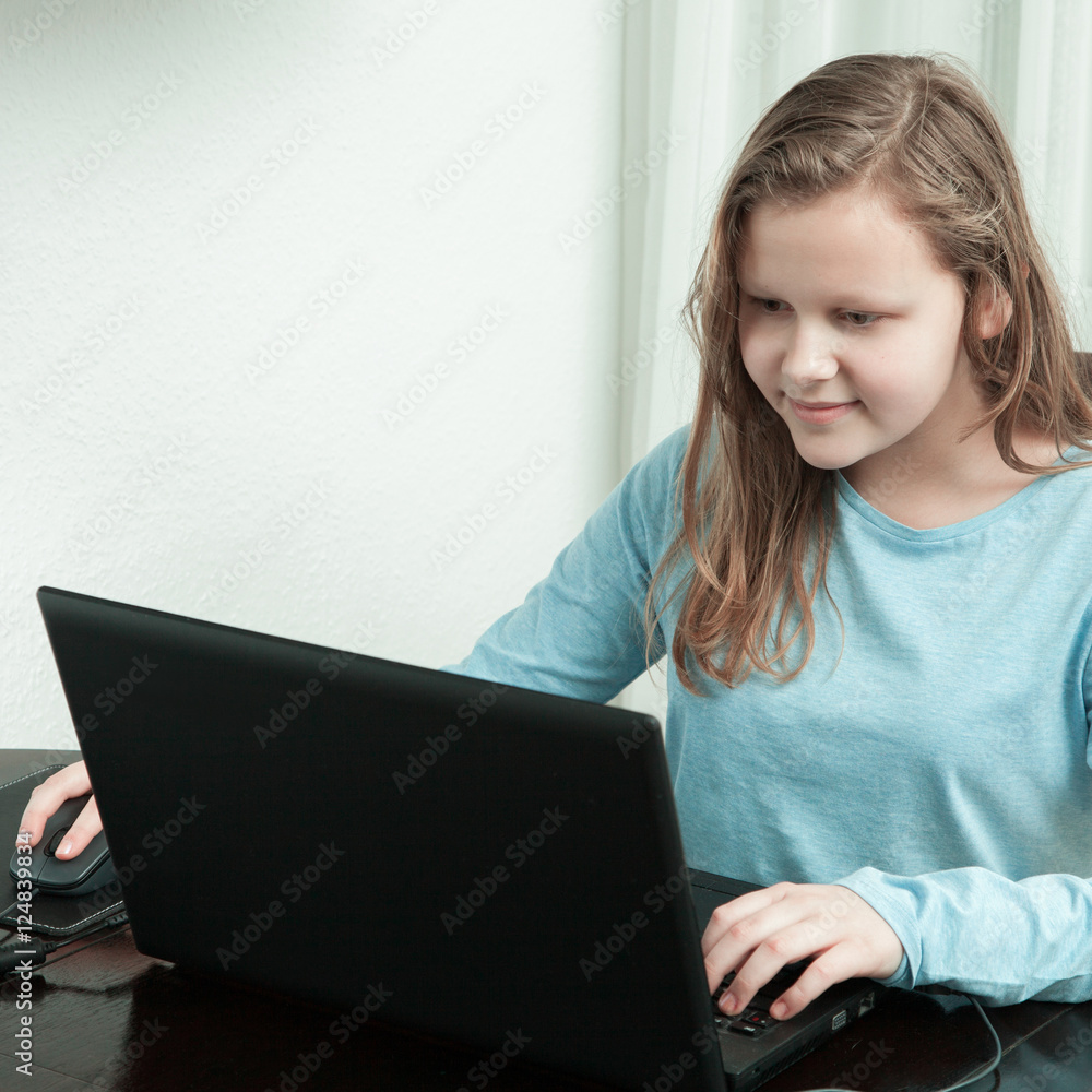 girl working on her homework on a laptop girl working on her homework on a laptop