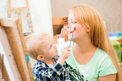 Mother and child draw a picture paints, art lesson