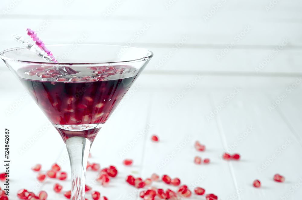Pomegranate martini with pomegranate seeds in a glass Pomegranate martini with pomegranate seeds in a glass