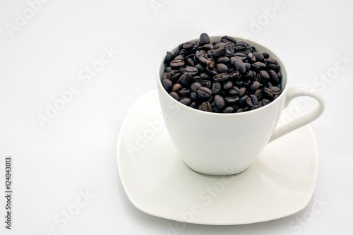 Black coffee beans in white cup on white background  healthy concept  Filtered process  Selective focus.