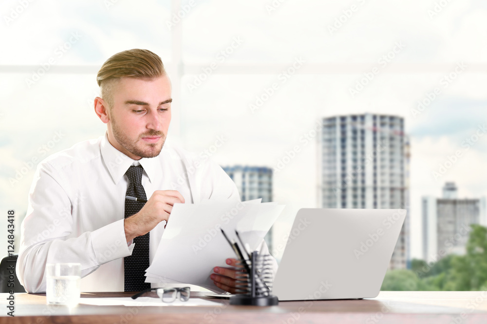 Young businessman working at modern office. Business concept.