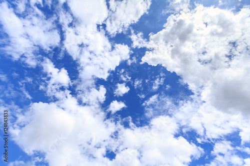 Blue sky background with white clouds. The vast blue sky and clouds sky on sunny day. White fluffy clouds in the blue sky.