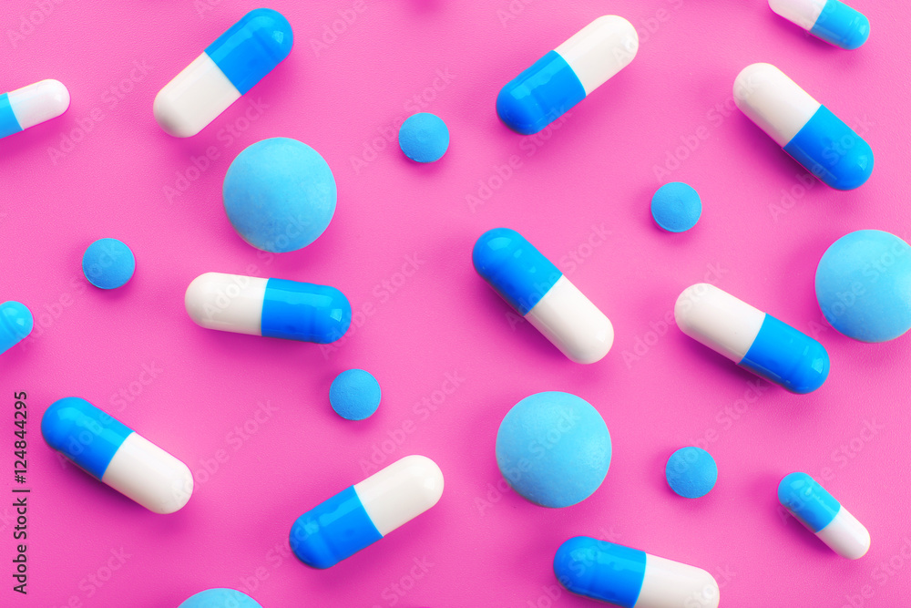 Color pills on pink background Color pills on pink background