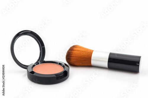 Closeup of face powder and makeup brush.