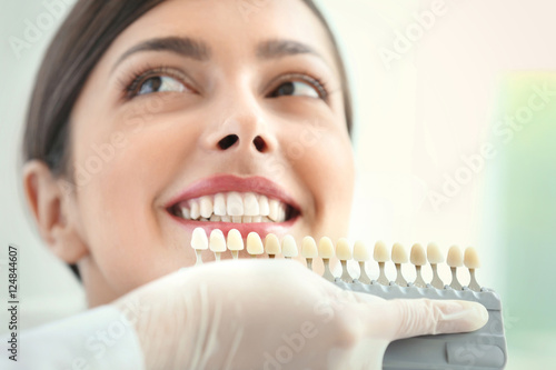 Dentist matching teeth colour in office