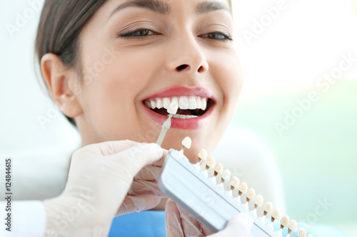 Dentist matching teeth colour in office